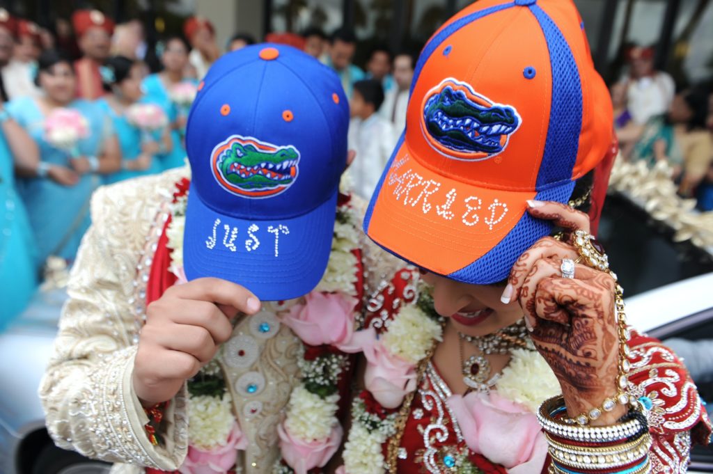 Bride and groom showing off "Just Married" Florida Gator hats