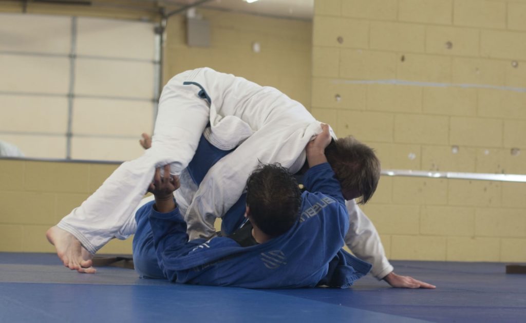 Jiu Jitsu instructor showcasing moves on a partner