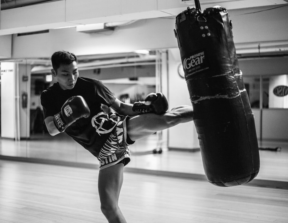 Kickboxing instructor training with a punching bag