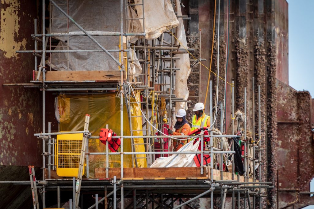 General contractors on top of scaffolding at a work site