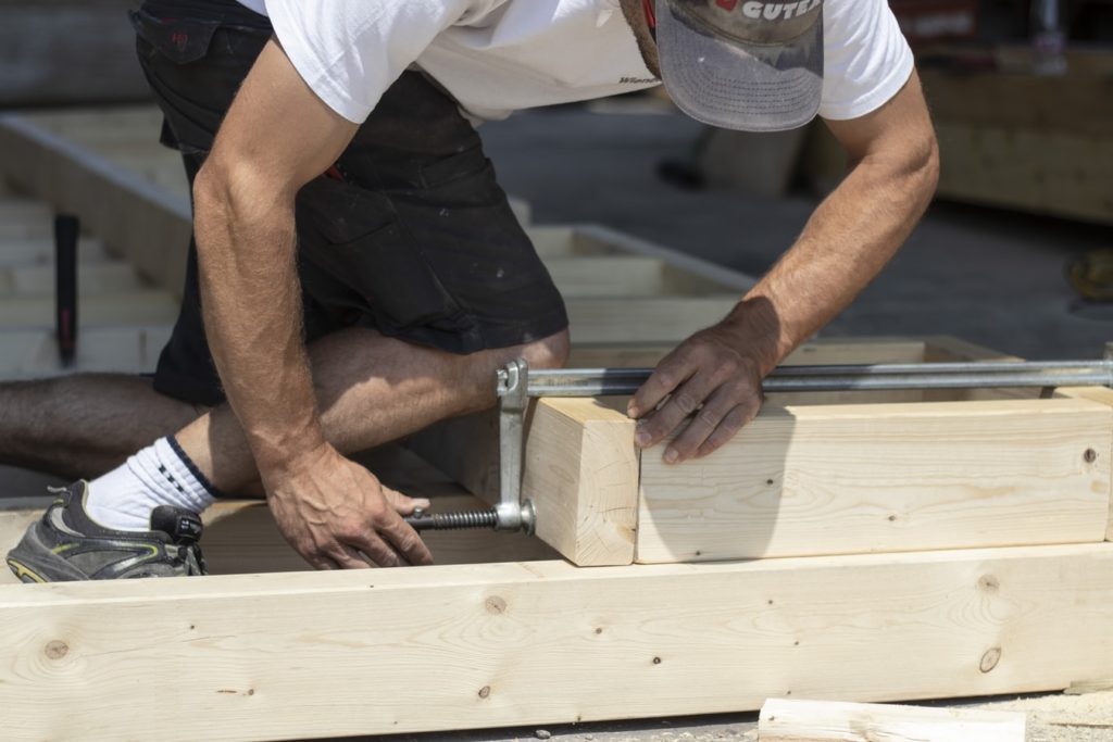 Carpenter clamping blocks of wood together