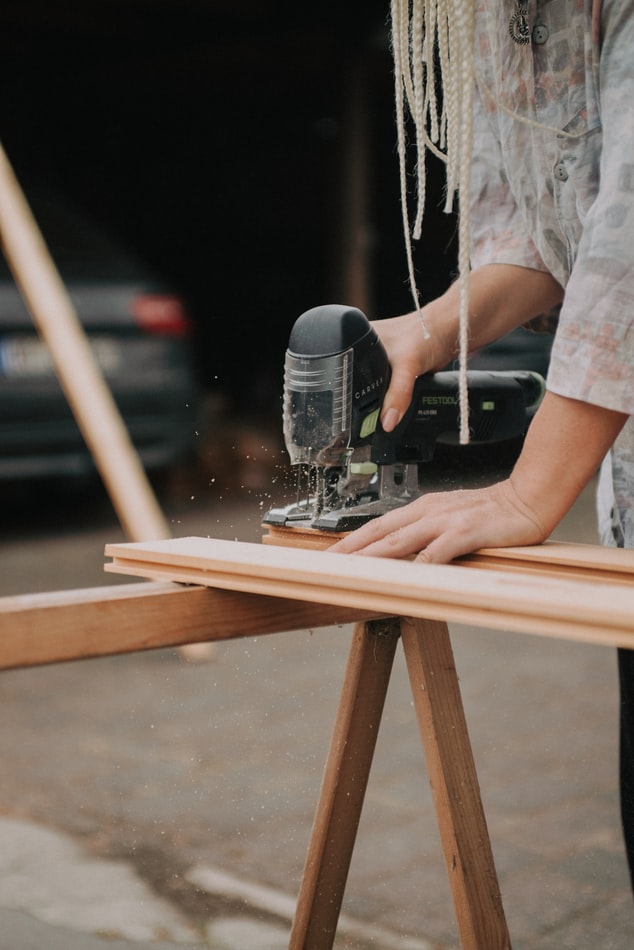 Carpenter sawing a piece of wood