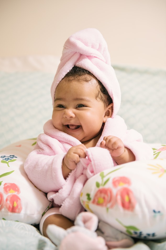 Small baby in a pink bathrobe