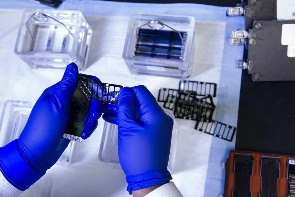 Phlebotomist preparing vials for samples in a laboratory