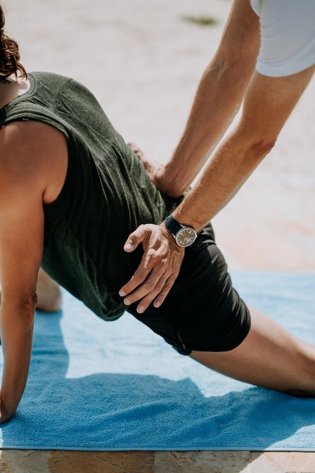 Physical therapist helping client to stretch