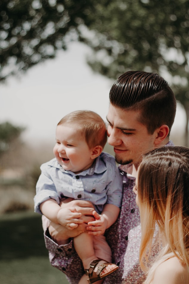 Young parents holding their baby